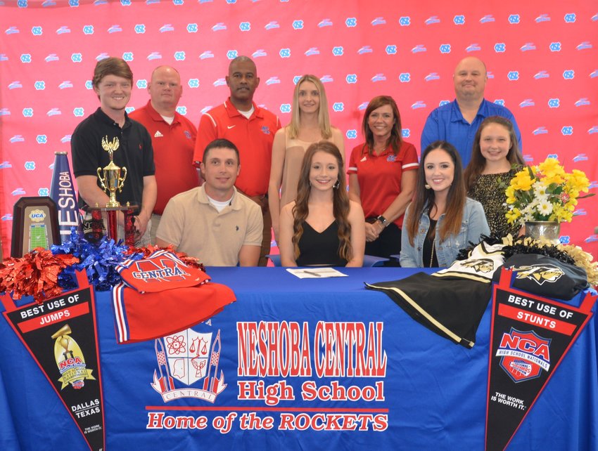 With her at her signing ceremony are, front row, from left, her dad Todd Verry; Natalie Verry; and her mom Ashley Verry. Second row, from left, are her brother Austin Verry; Assistant Principal Brent Pouncey; Assistant Principal LaShon Horne; Cheer Coach Nikki Morrow; Assistant Principal Dana McLain; and Principal Jason Gentry.